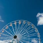 a large ferris wheel sitting under a blue sky