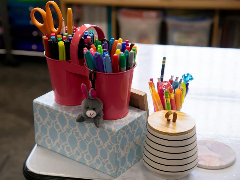 a stack of pens and pencils on a table