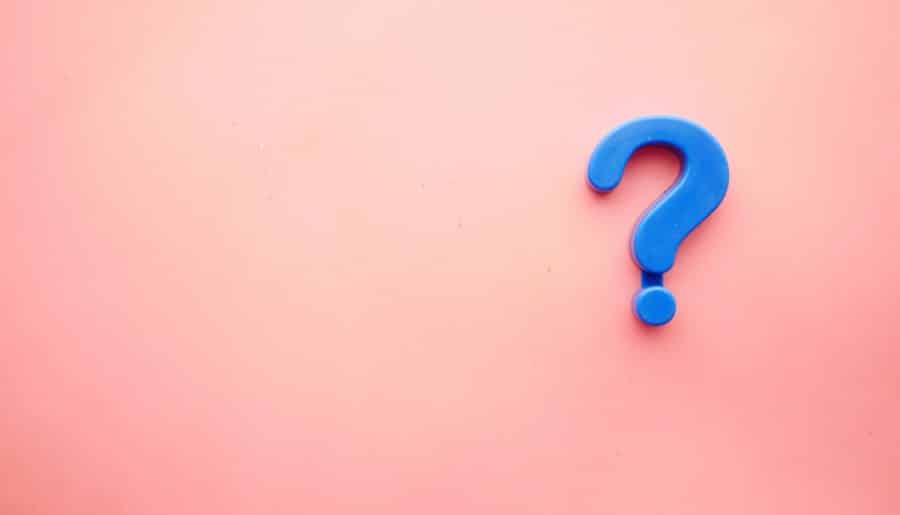 a blue question mark on a pink background