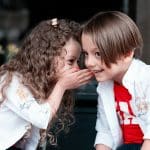 woman in white long sleeve shirt kissing girl in white long sleeve shirt