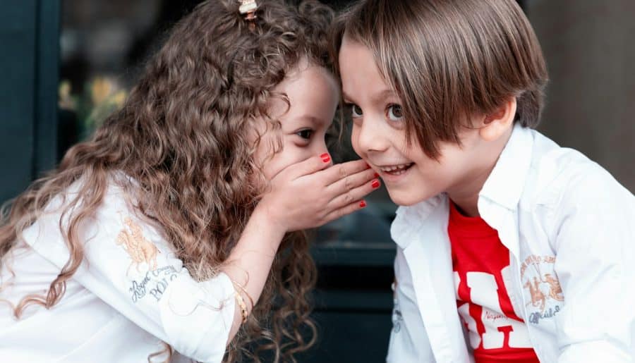 woman in white long sleeve shirt kissing girl in white long sleeve shirt