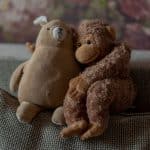 brown bear plush toy on brown textile